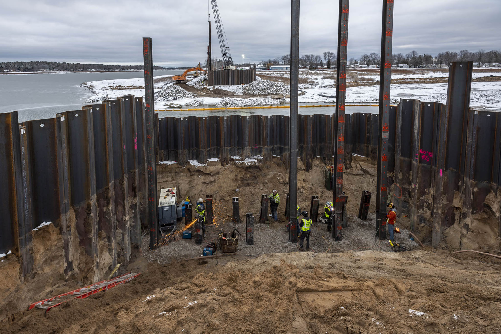 M-30 at the Tobacco River in Gladwin County. work on temporary bridge after May 2020 flood damage. Driving in steel sheeting and welding steel piles.